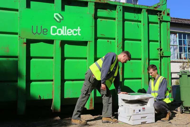 We Collect team loading electrical waste into a skip