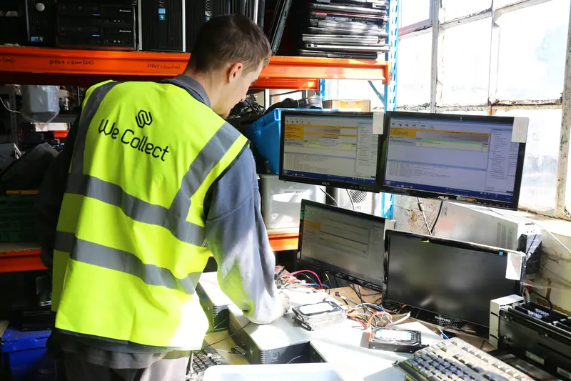We Collect team member logging equipment at a workstation